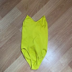 Bright yellow rubbed body suit